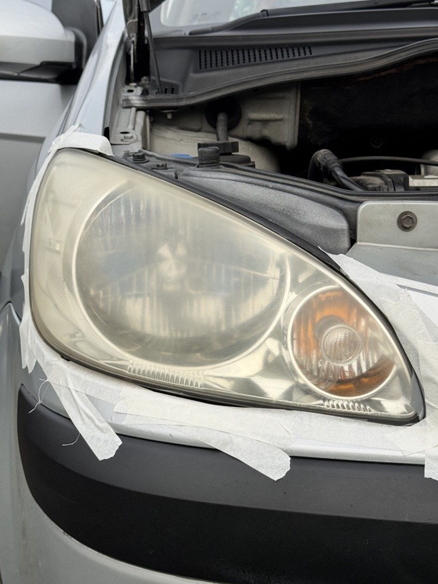 Hatchback headlight before restoration, hazy and dull